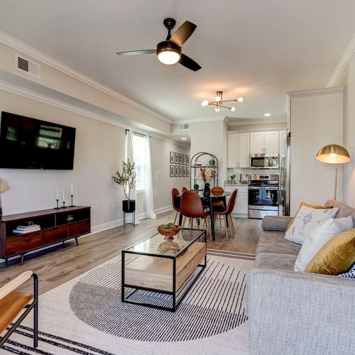 Airy open-concept living area w/ modern furnishings & natural light.