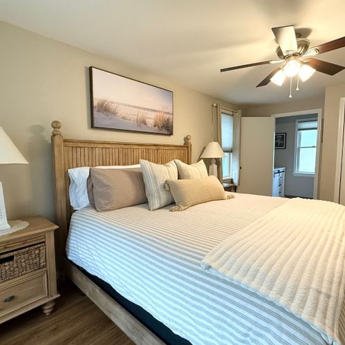 Bedroom #1:  features a king-size bed, ceiling fan, private television and private en suite full bathroom!