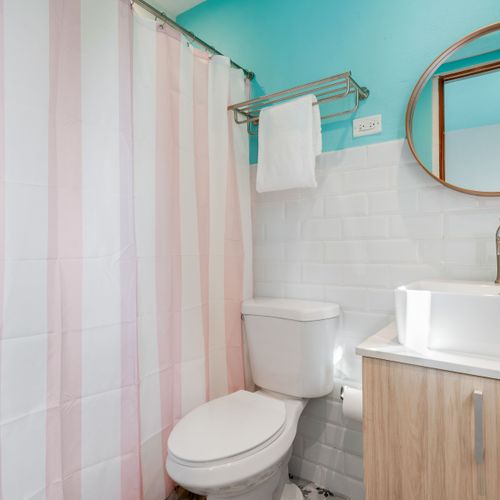 A bright bathroom with a double sink and a large mirror.