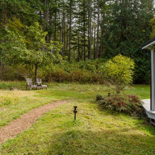Well-lit pathway leading to the house from parking area