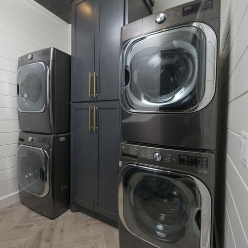 Spacious laundry room with 2 washers and dryers.