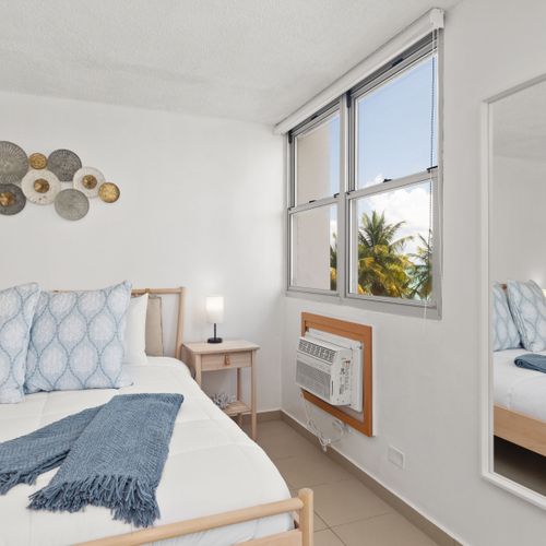 beachfront room with beach views, bed and wall art