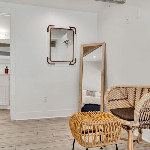 Warm corner w/ a full-length mirror & natural textures — a cozy finishing touch.