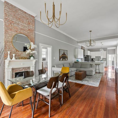 Gather in style! This beautifully designed open-plan dining and living area features exposed brick, modern furnishings, and plenty of natural light—perfect for hosting memorable meals and cozy nights in.