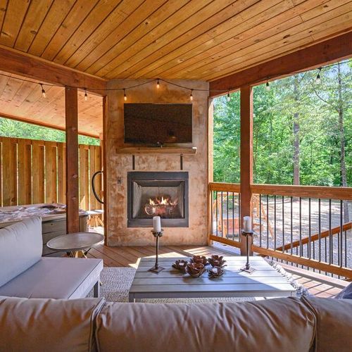 The bottom covered patio features an oversized outdoor sectional + fireplace.
