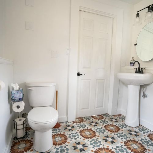 - refresh in a charming bathroom with vintage style patterned tile flooring
- pedestal sink and oval mirror with sleek black fixtures for a modern touch
- thoughtful essentials like tissue, extra toilet rolls, and hand soap included