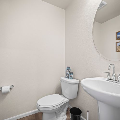 Clean, well-appointed half bathroom stocked for your stay.