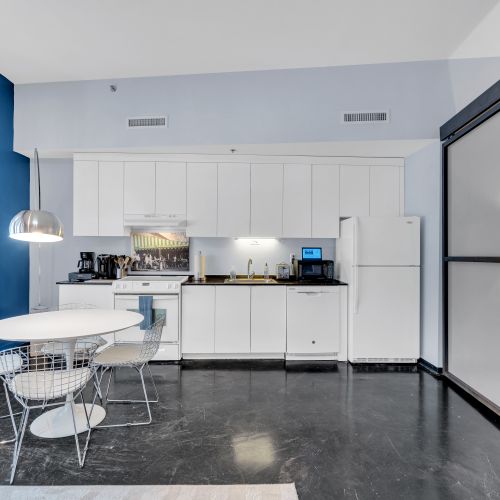 Your home away from home—this sleek, fully equipped kitchen and cozy dining area offer everything you need to enjoy meals during your stay in New Orleans.