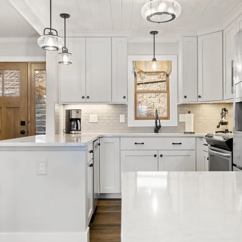 KITCHEN (MAIN FLOOR):  The home has a beautiful modern kitchen with all appliances (including a dishwasher) and a good supply of cooking and dining utensils