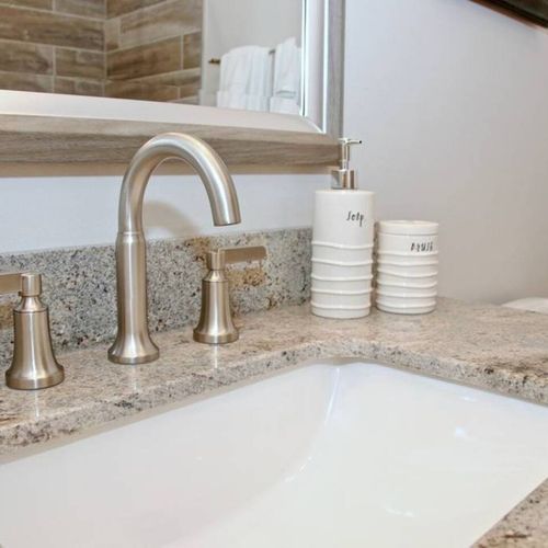 Polished silver fixtures & a deep sink — ready for your morning routine.