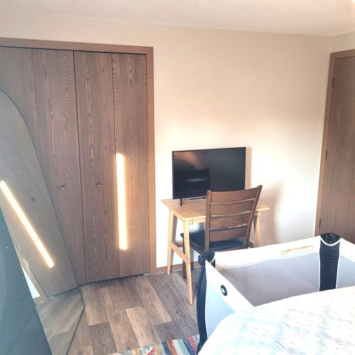 BEDROOM #2:  Features a queen-size bed, crib, ceiling fan, closet, nightstands, lamp, mirror, and a private desk and television