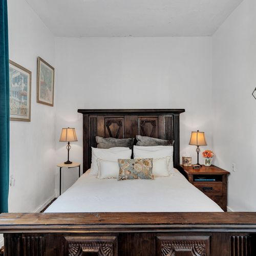 Warm guest bedroom w/ timeless style & inviting comfort.
