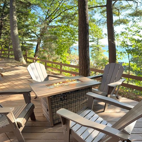EXTERIOR:  The fire table on the deck with Crystal Lake in the background