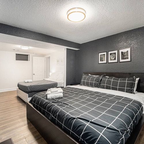 - sleek and stylish, this spacious room features two cozy beds and sharp contrast tones
- grid patterned bedding and bold black walls give off a cool, urban energy
- great for families or friends looking for both comfort and visual edge