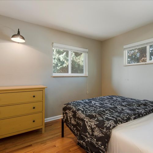 The secondary bedroom is fitted with a dresser for extra storage and surface space.