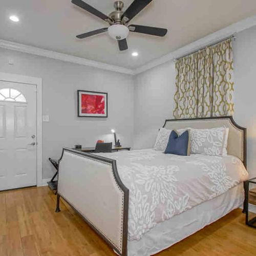 Restful master bedroom w/ crisp white bedding & easy access to a private en-suite bath.