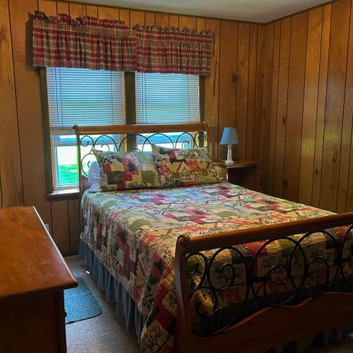 Bedroom #2: features a full-size bed, nightstand, lamp, dresser, and closet.