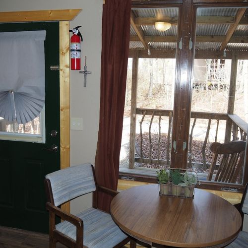 Main room:  features a small dining table with chairs, kitchenette  / sink, one twin-on-full bunk bed, and one twin-on-twin bunk bed.