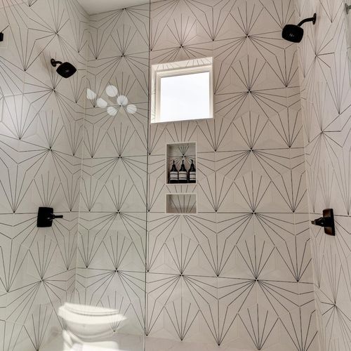 Showstopping bath w/ double shower heads & bold, fabulous tilework.