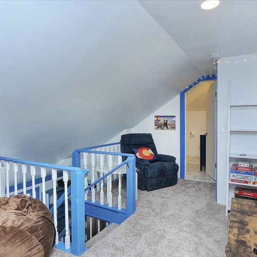 - peaceful bedroom with rustic headboard, nature themed artwork, and cozy blue bedding
- relax in the hanging hammock chair or enjoy views from the tall sunlit window
- inviting and restful space with soft carpeting and charming wilderness accents