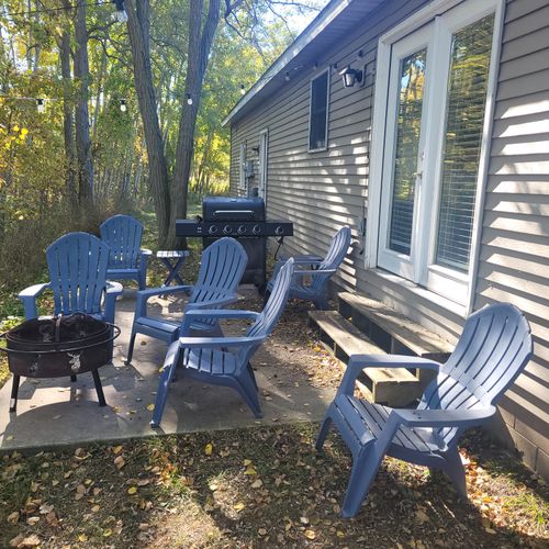 EXTERIOR:  The backyard patio with bonfire ring, chairs, and a propane grill