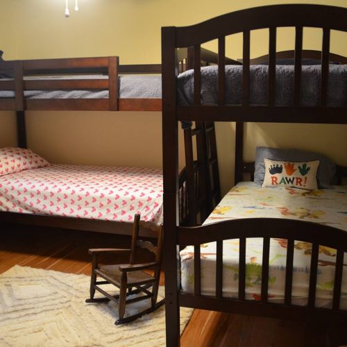 This room features 2 sets of bunk beds, each with a full-sized mattress, providing sleeping space for up to 4 people.