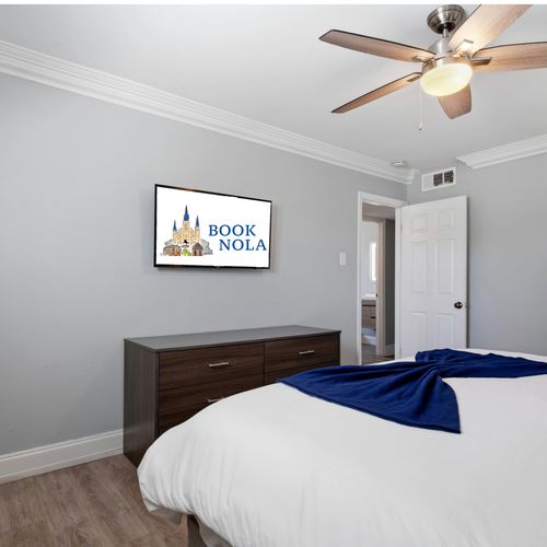 Cozy bedroom nook w/ a bed & wall-mounted TV for relaxed evenings.