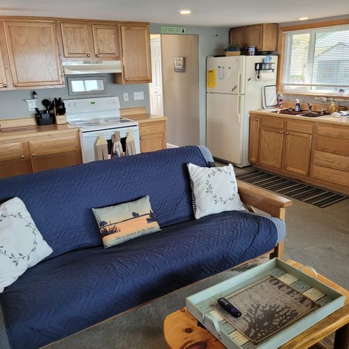 Living room:  cozy living room with a futon, chair, streaming television, and a great view of van etten lake!
