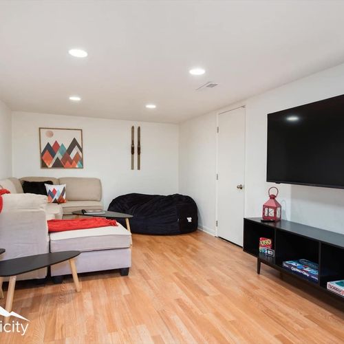 - comfy downstairs retreat with sectional sofa, large bean bag, and vibrant art
- watch movies or play games on the oversized flat screen tv
- hardwood floors and recessed lighting create a warm modern vibe