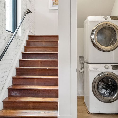 Convenient in-unit laundry tucked just off the stairway—perfect for extended stays and fresh outfits.