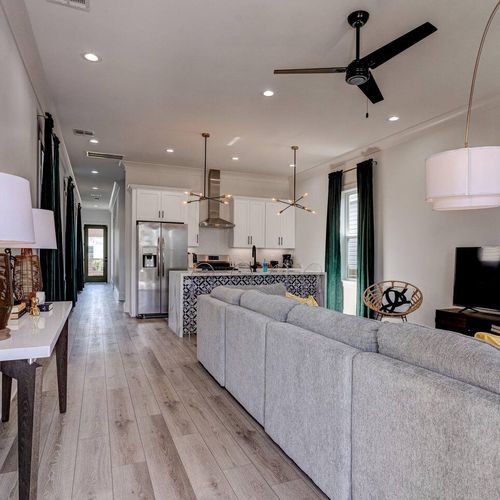 Open-concept living & kitchen w/ light wood floors & a bright, airy feel.
