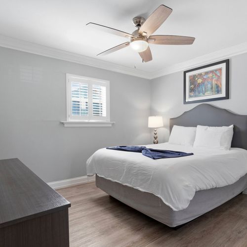 Calm bedroom w/ a plush bed & soft tones for restful nights.