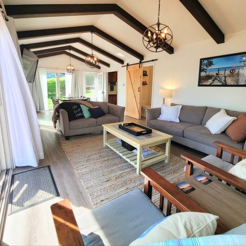Living room:  the cottage features a very bright, modern, and fun living room with a beachy design and a wall-mounted television with live streaming via roku.