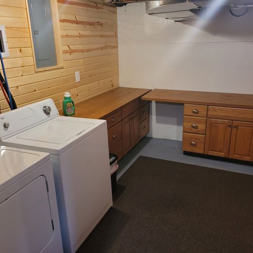 Laundry room:  there is a large laundry room in the basement that includes a washer, dryer, folding area, iron, and ironing board.