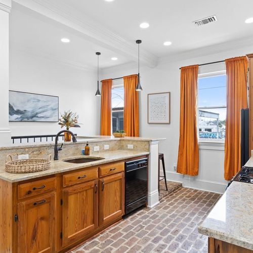 Fully stocked kitchen w/ warm wood cabinets, black appliances & plenty of counter space.