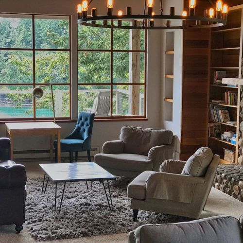 Living room seating and game table with custom stone fireplace