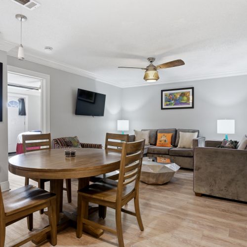 Gather around the dining table in this open, airy living area made for easy meals together.