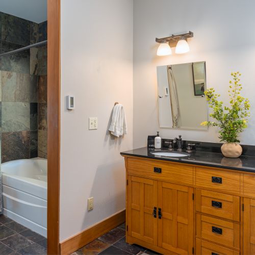 The main-floor bathroom is your personal escape, featuring a relaxing bathtub and two sinks for convenience. Fresh linens, premium toiletries, and all essentials are provided to make your stay effortless and indulgent.