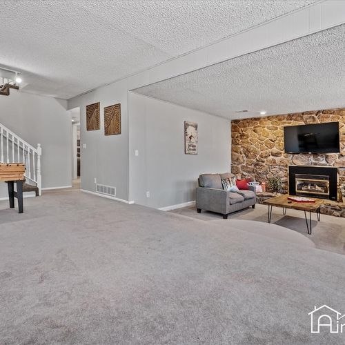 - stylish carpeted lower level featuring foosball table, games, and lounging areas
- ideal for movie nights or board games with friends in this cozy entertainment hub
- recessed lighting and neutral decor keep the space bright and versatile