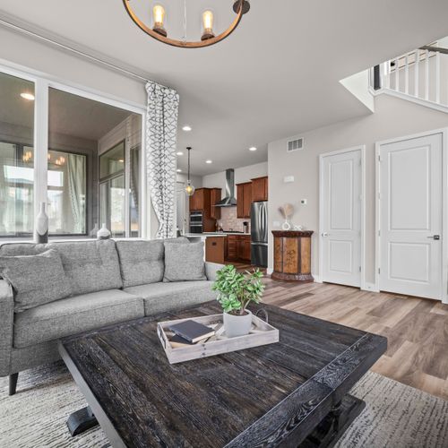 Bright, well-lit living room flowing seamlessly into the kitchen.