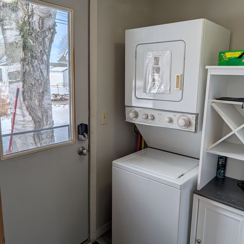 LAUNDRY:  There is a stacked washer and dryer next to the back door.