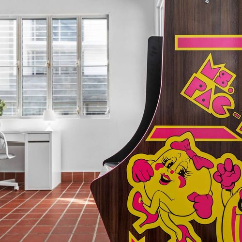 An ideal room for unwinding or getting work done, complete with a distinctive touch—an arcade machine.