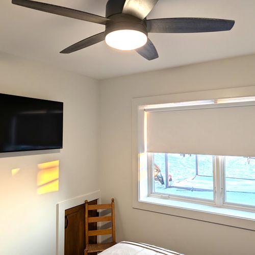 BEDROOM #4 (LOWER LEVEL):  Features a queen-size bed, ceiling fan, dresser, mirror, nightstand, nightlamps, private television, and a great view of Crystal Lake!