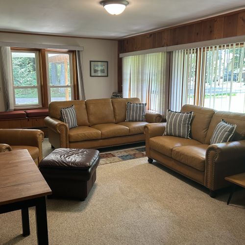 Living room: the cabin has a very cozy living room with a sofa, loveseat, comfy chair, and live streaming television.