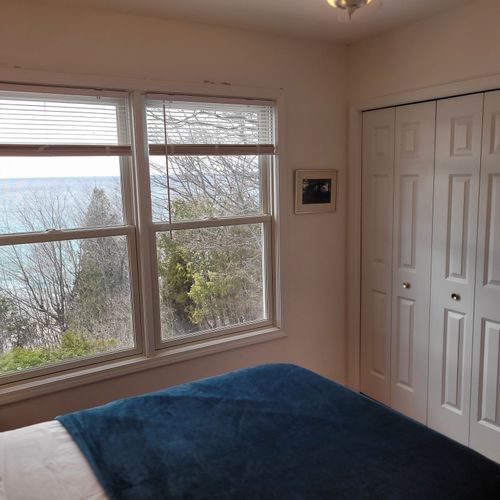 Bedroom #3 (upper level):  features a full-size bed, ceiling fan, closet, and great views of lake michigan.