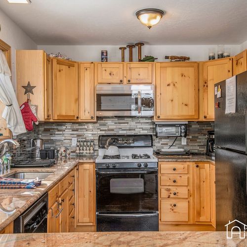 - cook up delicious meals in a fully equipped kitchen with rustic pine cabinetry & stone backsplash
- enjoy stainless steel appliances including gas stove & microwave for effortless cooking
- thoughtful layout offers charm & convenience for even stay