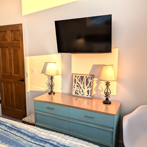 BEDROOM #3 (UPPER LEVEL):  Gorgeous top floor (third floor) bedroom with a king-size bed, nightstands, nightlamps, private television, dresser. closet, amazing view of Crystal Lake, and private entrance to the top floor bathroom!