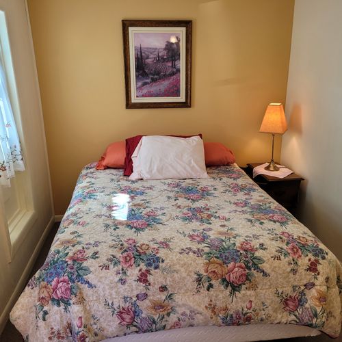 Bedroom #1:  features a queen-size bed, dresser, closet, and chair.