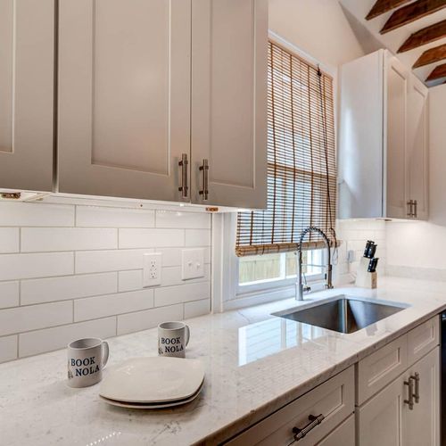Bright kitchen w/ a deep sink & classic subway tile backsplash.