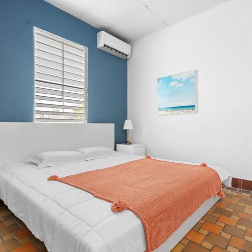 Relax in this cozy bedroom with natural light streaming through the window.